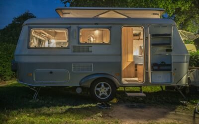 caravane blanche et marron à côté d'un arbre